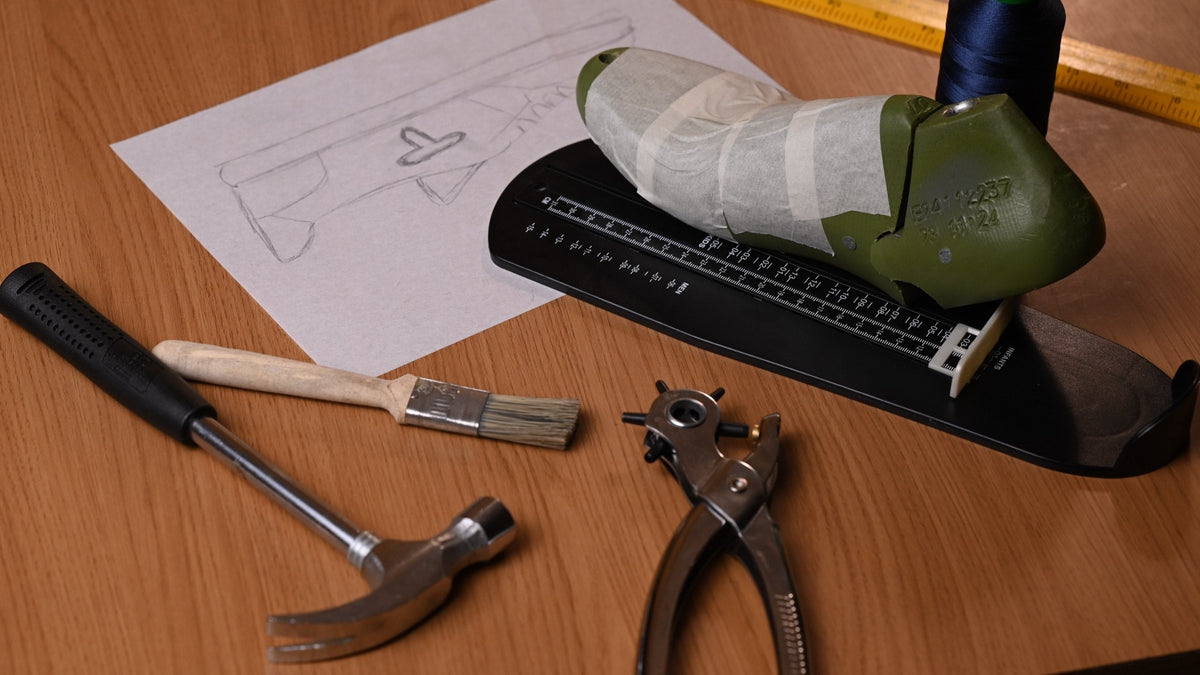 Taped last on a sizing stick beside a hammer, brush and punch pliers