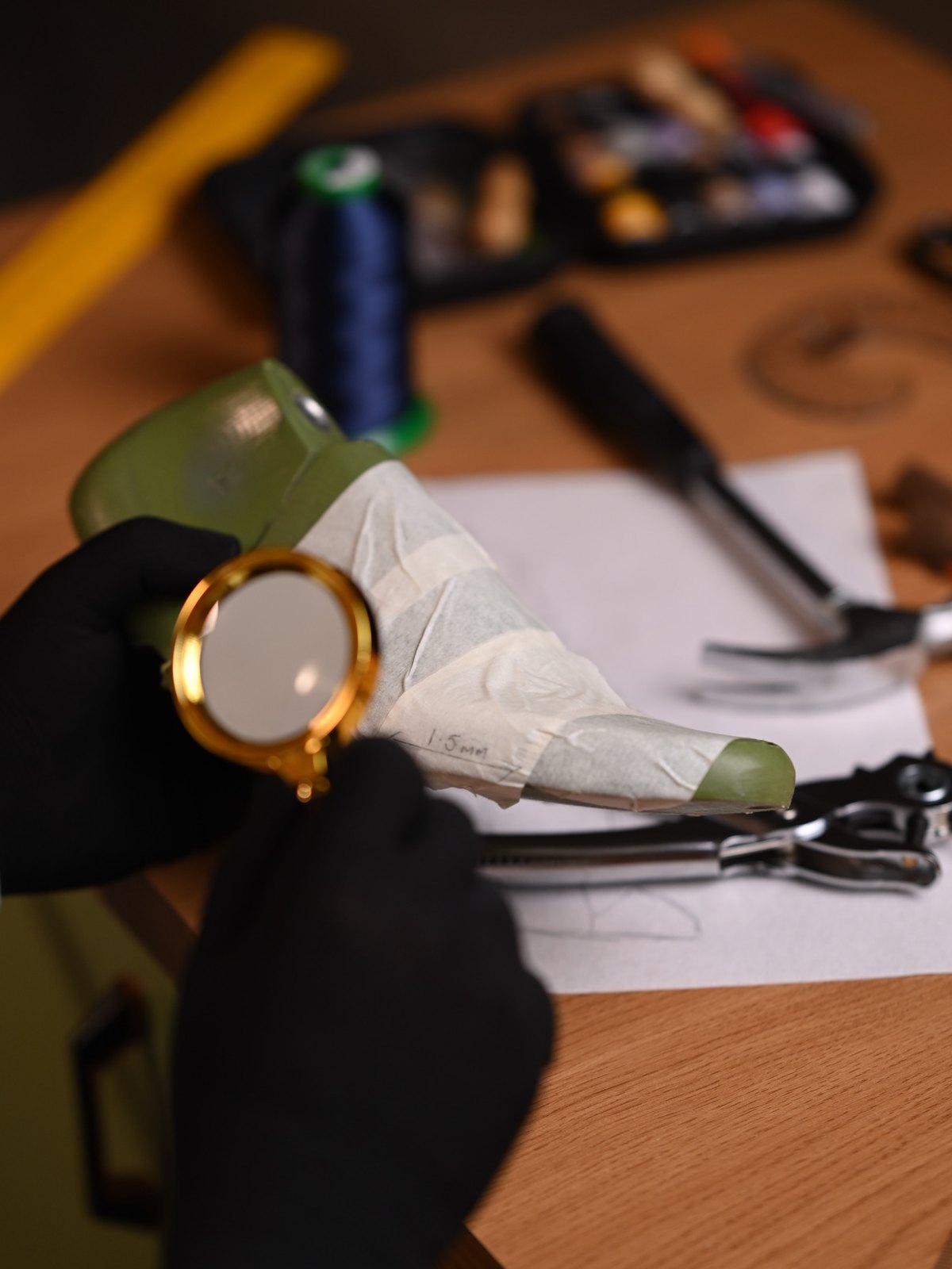 Magnifying glass over a taped shoe last