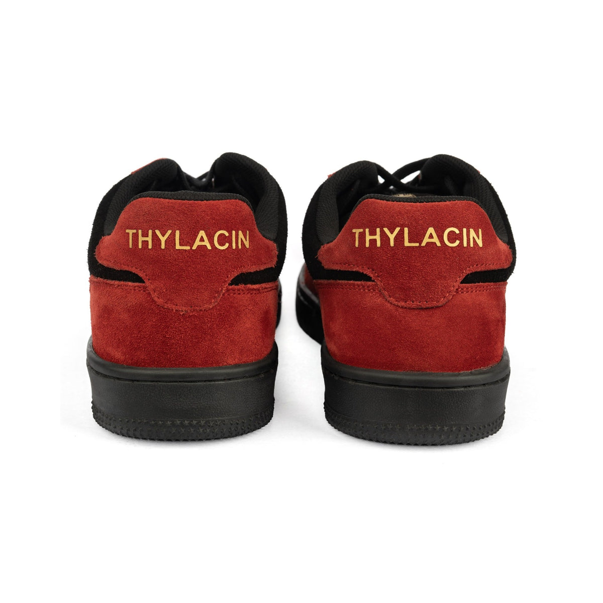 Thylacin Ember Wolf low-top sneakers in crimson red and black suede — heel view of a pair