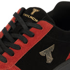 Thylacin Ember Wolf low-top sneaker in crimson red and black suede — close-up of the suede and logo badge on the shoe