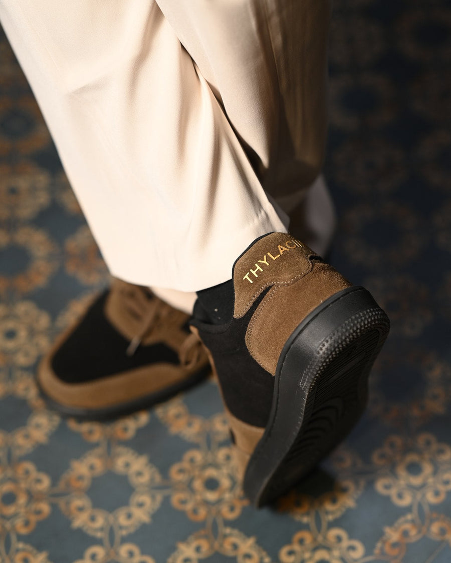 The Copper Jackal sneaker heel with THYLACIN lettering, mid-step