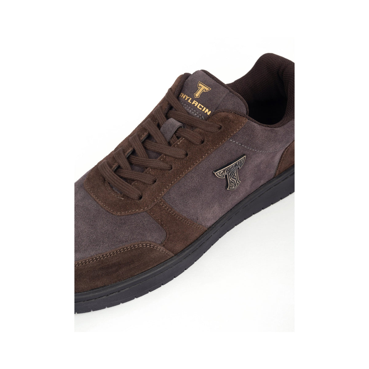 Thylacin Shadow Lynx low-top sneaker in brown and slate suede — close-up of the suede and logo badge on the shoe