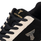 Thylacin Woodland Fox low-top sneaker in black and cream suede — close-up of the suede and logo badge on the shoe